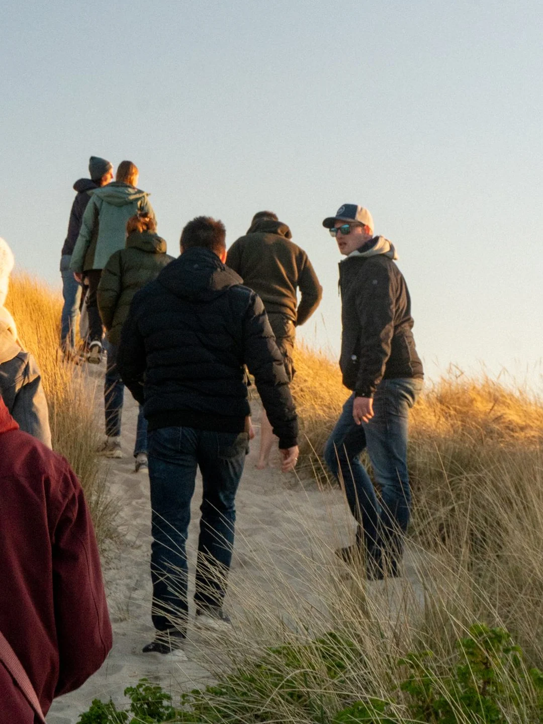 Kitecamp Dänemark: die Camp-Gruppe steigt im Abendlicht über den Dünenpfad zur Nordsee